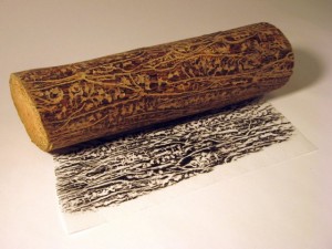 Jeff Woodbury, "beetlerunes rubbing with log, in process," 2012, gravestone rubbing wax on paper, 12 x 9 in